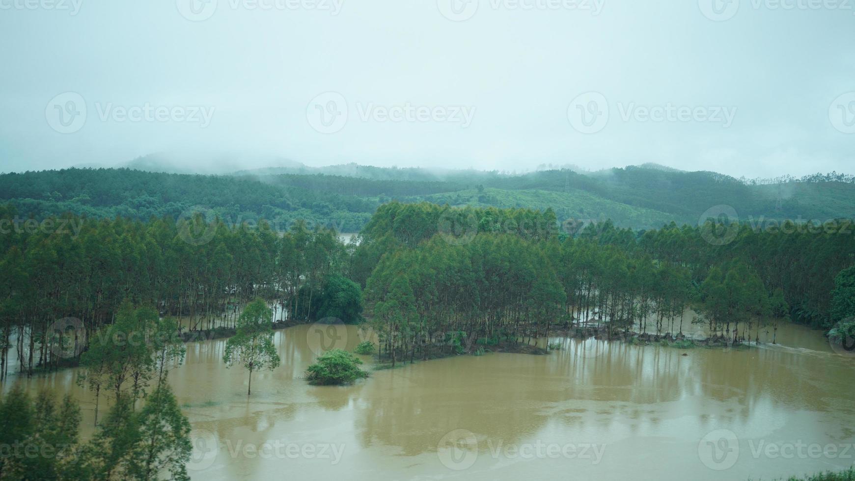 The beautiful countryside view from the runny train on the south of the China in the rainy day photo