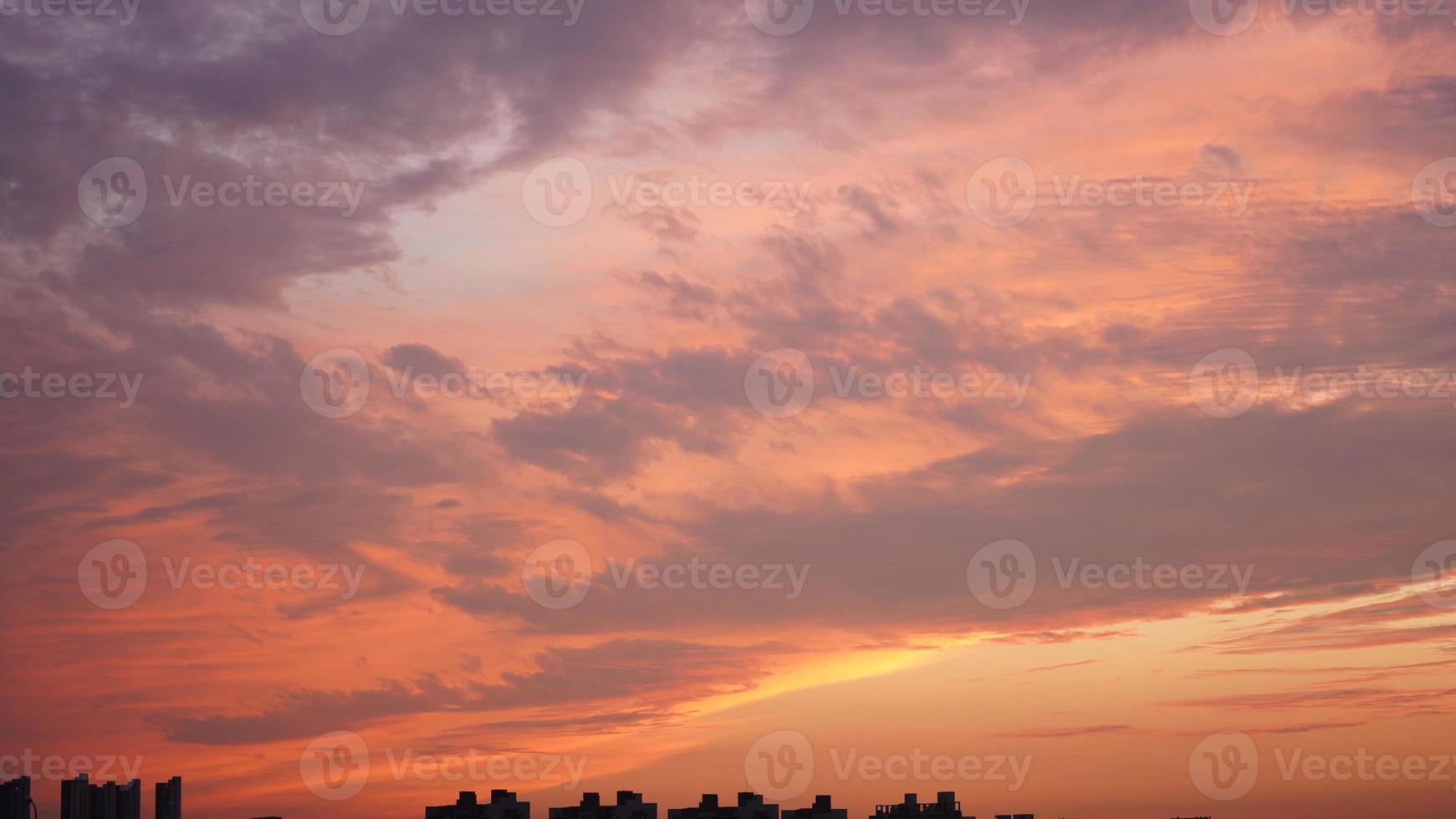 The beautiful sunset sky view with the colorful clouds and warm lights in the sky photo