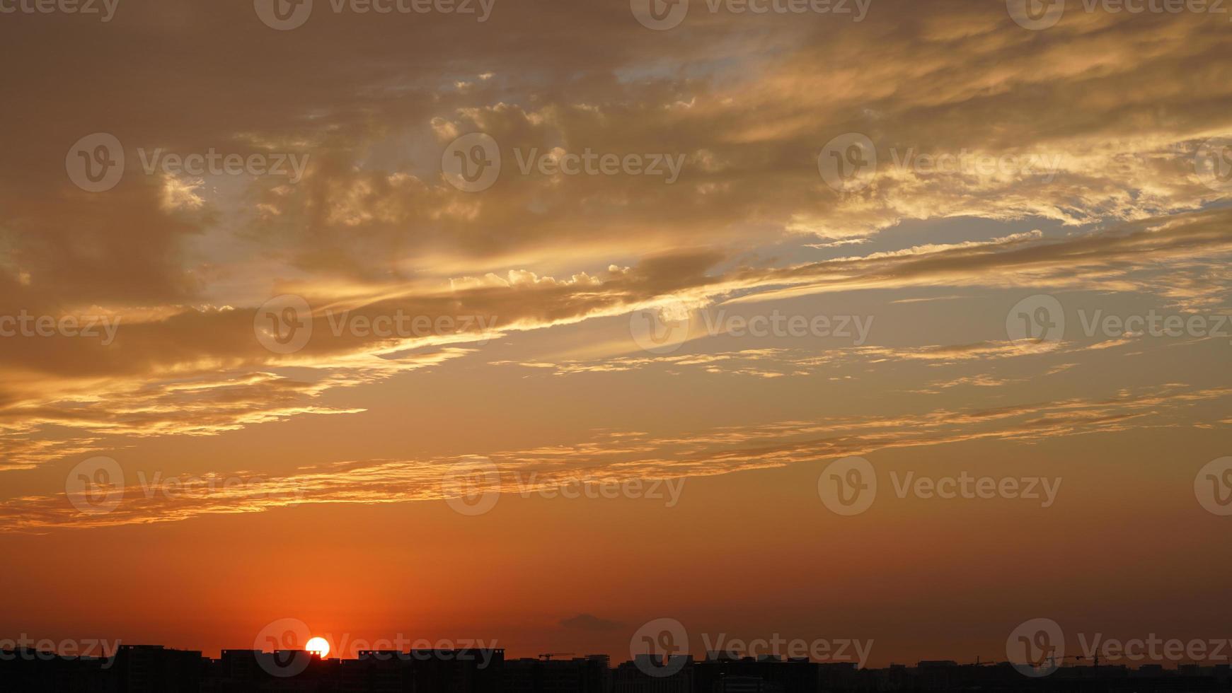 The beautiful sunset sky view with the colorful clouds and warm lights in the sky photo