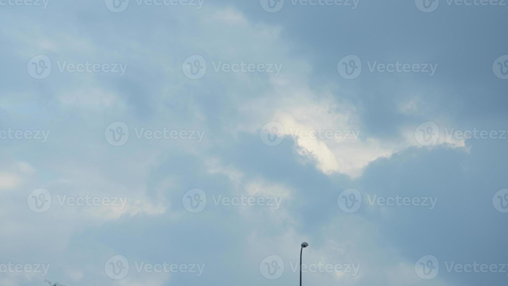 The summer sky view with the white clouds and blue sky as background photo