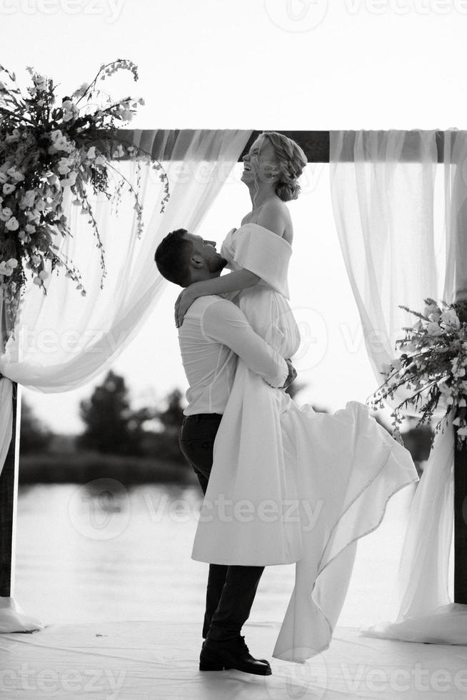 bride and groom against the backdrop of a yellow sunset photo