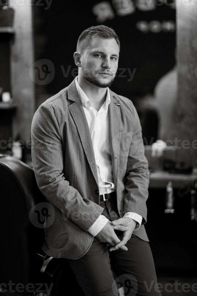 portrait of a young guy groom at the training camp in the barbershop photo