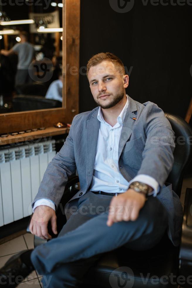 portrait of a young guy groom at the training camp in the barbershop photo