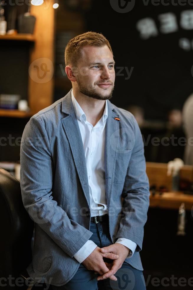 portrait of a young guy groom at the training camp in the barbershop photo