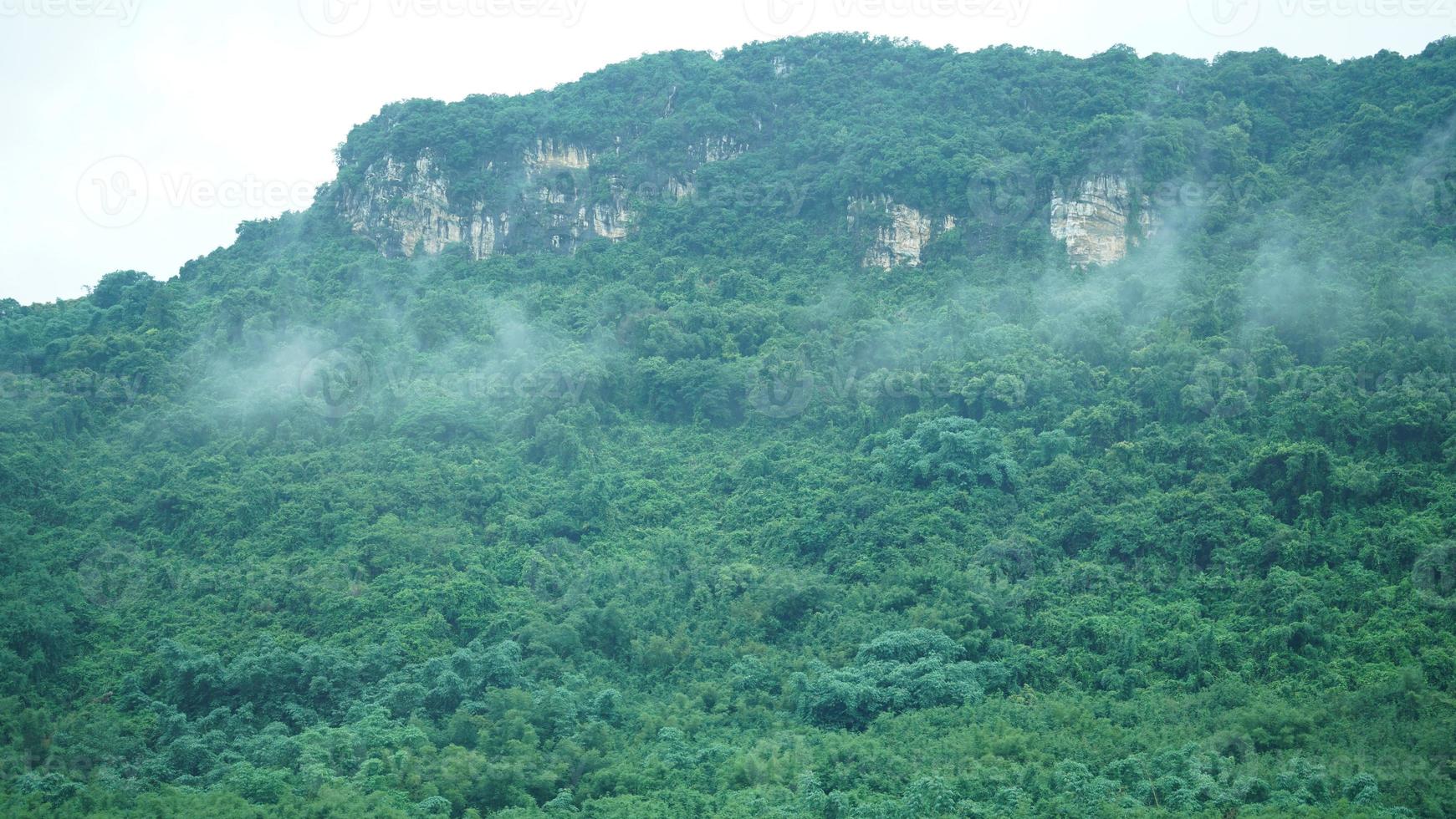 The beautiful mountains view with the fog during the rainy day photo