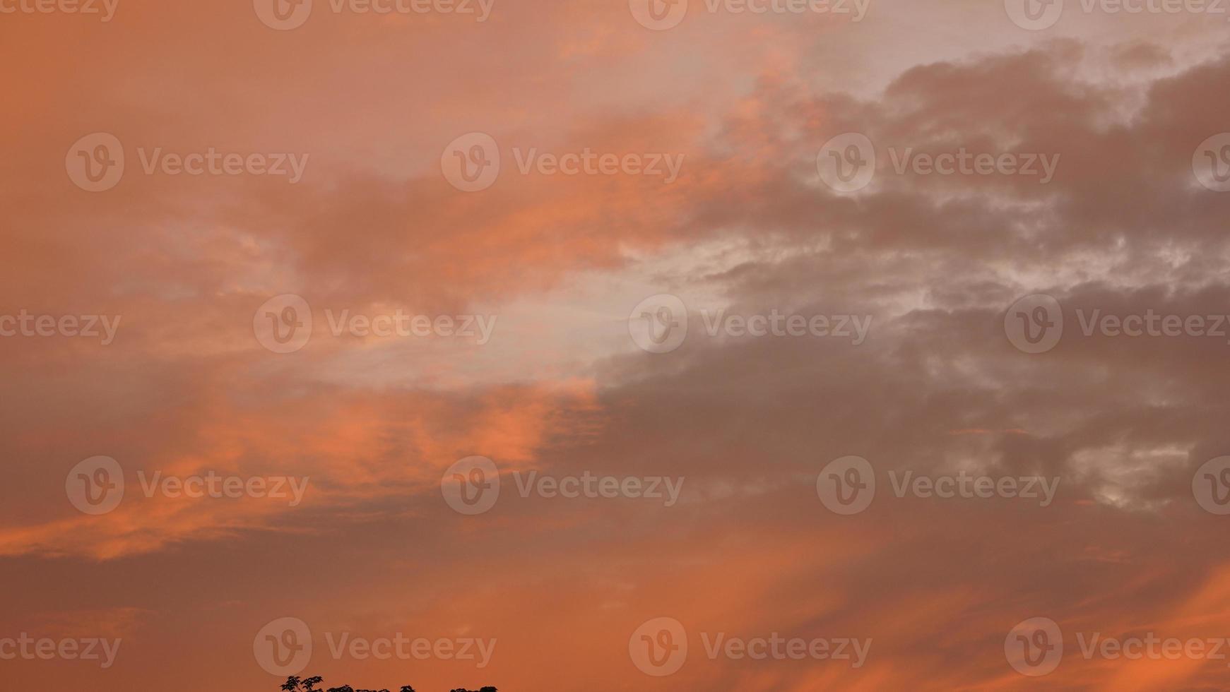 The beautiful sunset sky view with the colorful clouds and warm lights in the sky photo
