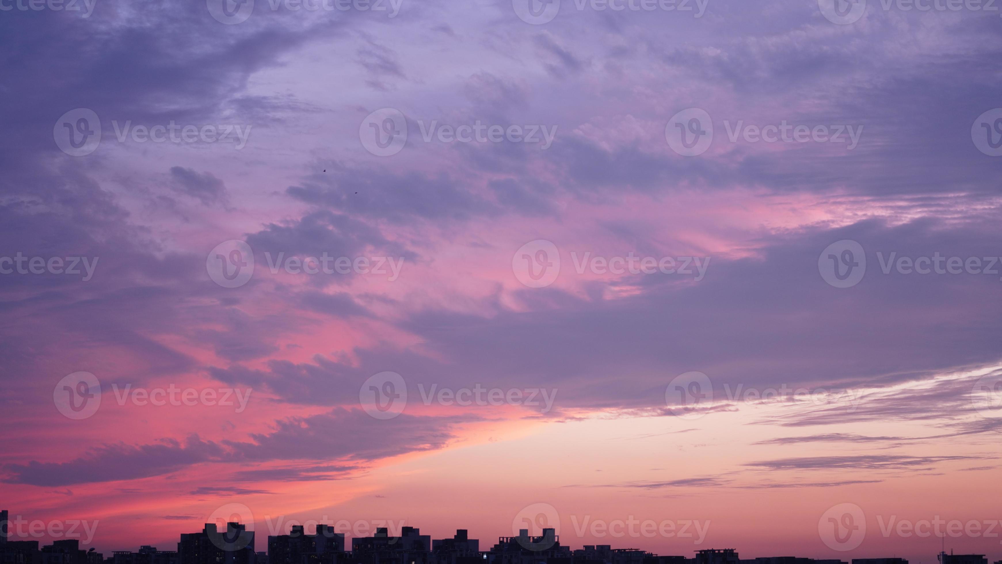 The beautiful sunset sky view with the colorful clouds and warm lights
