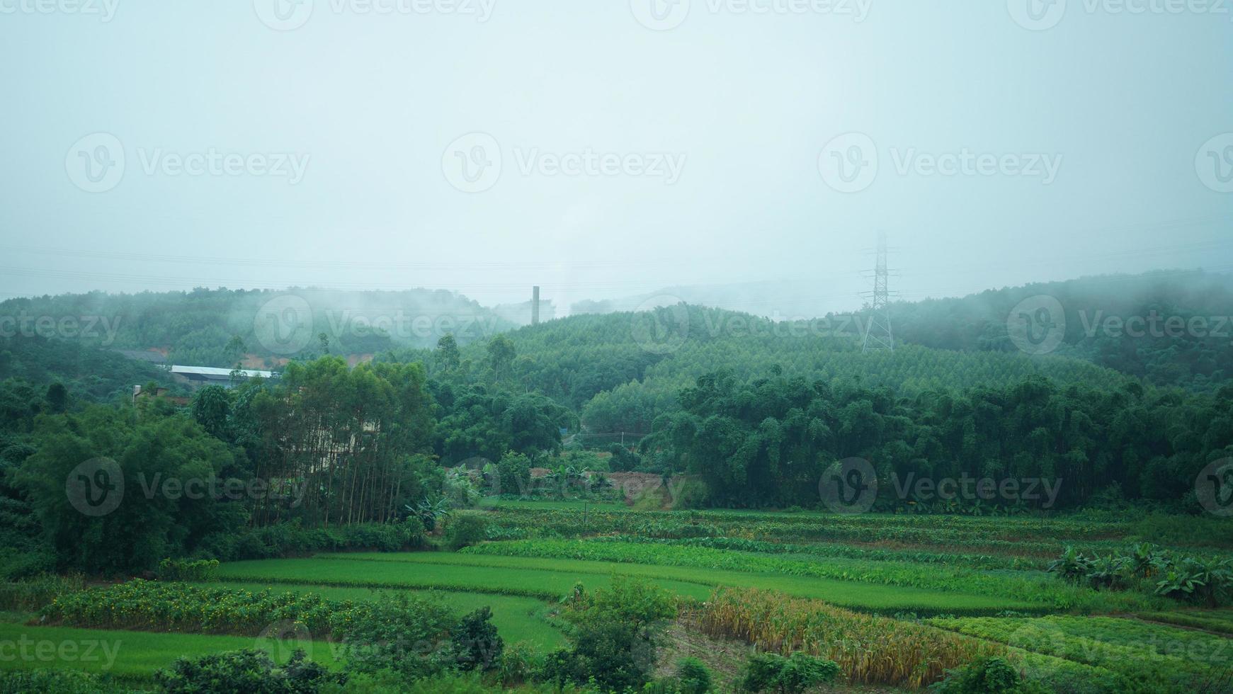 The beautiful countryside view from the runny train on the south of the China in the rainy day photo