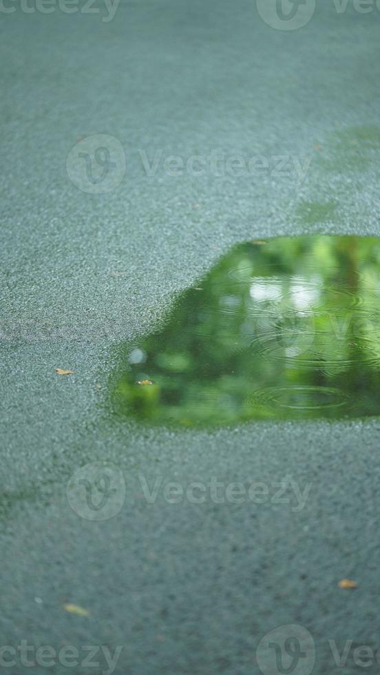 The little water pool on the road  in the city after the rain photo