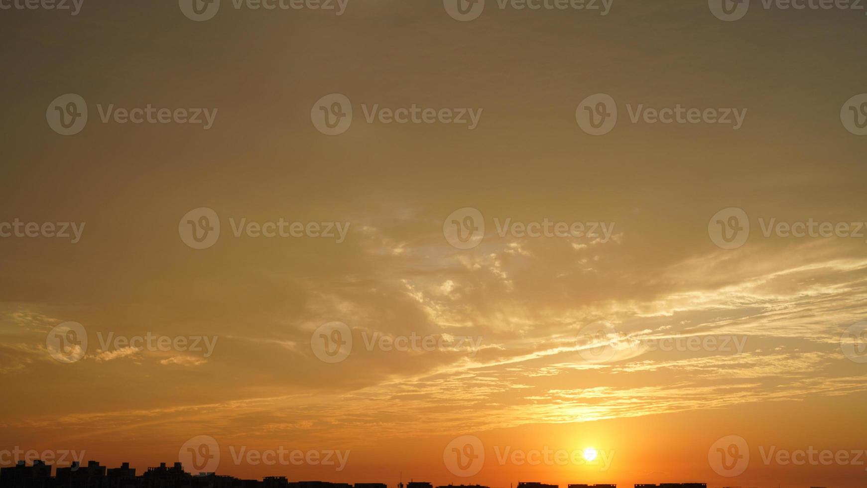 The beautiful sunset sky view with the colorful clouds and warm lights