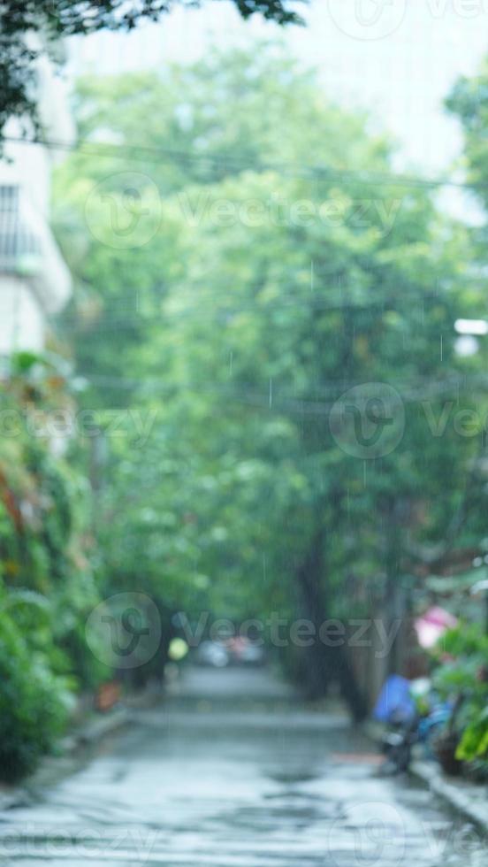 The rainy day view in the city with the wet road and rainy droplets down photo