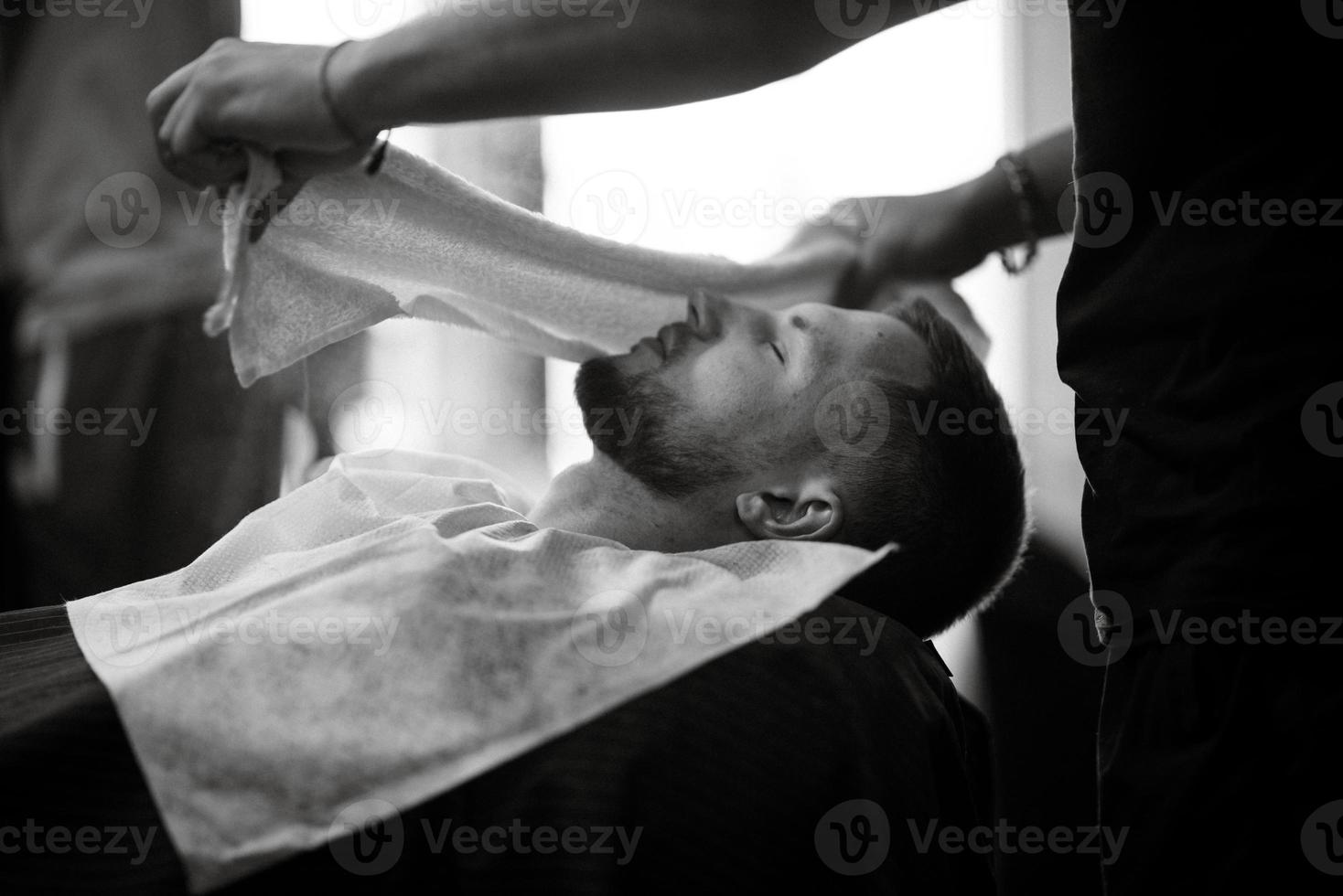 portrait of a young guy groom at the training camp in the barbershop photo