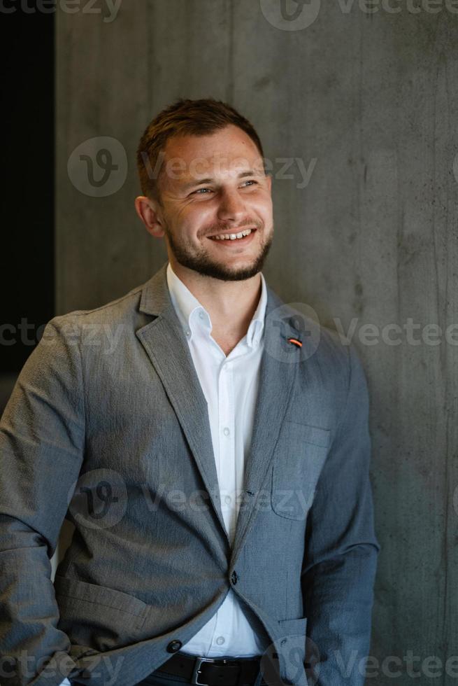 portrait of smiling groom with beard photo