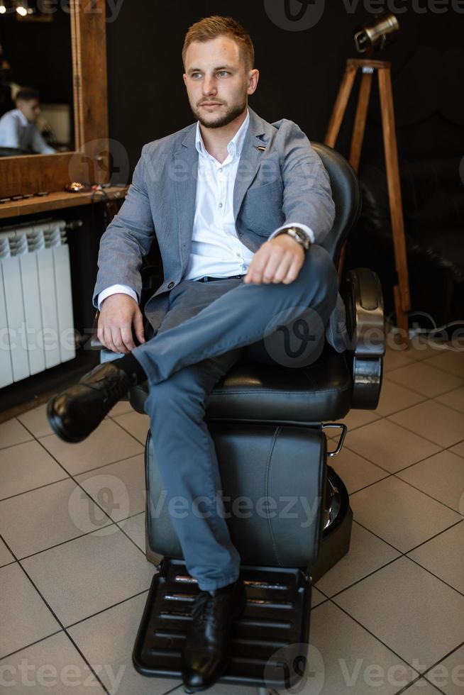 portrait of a young guy groom at the training camp in the barbershop photo