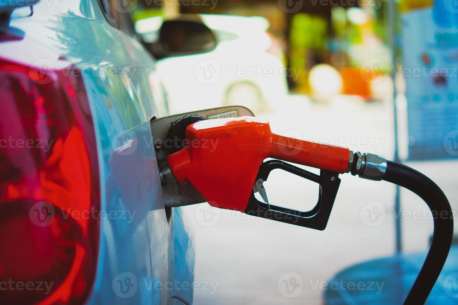 Gas station nozzles. Cars that are refueling in the gas station. The concept of fuel prices has changed. photo