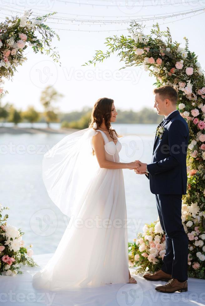 wedding ceremony on a high pier near the river photo