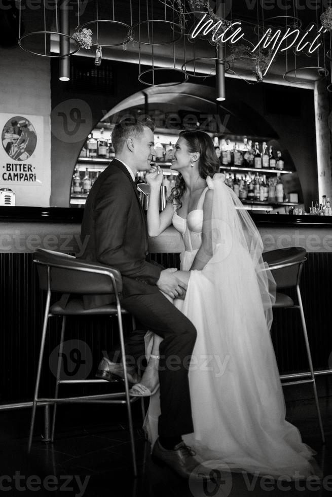 bride and groom inside a cocktail bar photo