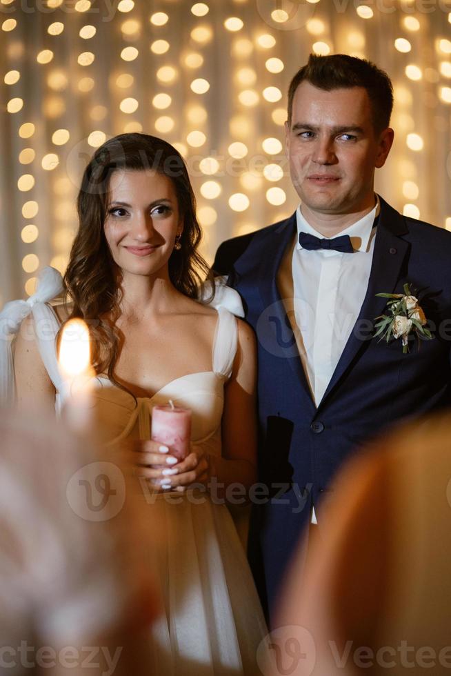 ceremony of handing over the wedding fire from parents to children with candles photo