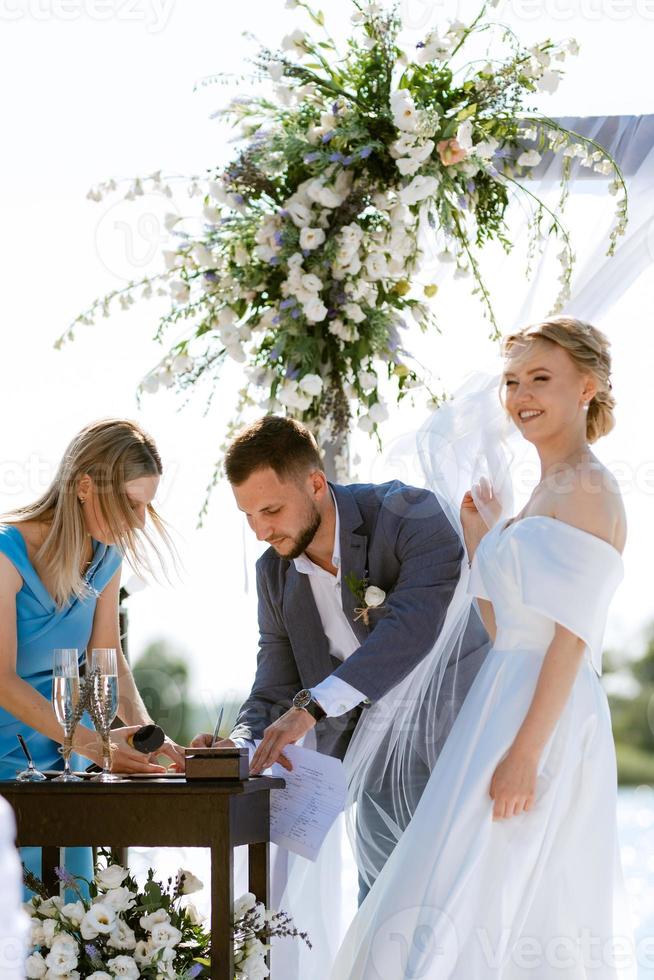 wedding ceremony on a high pier near the river photo