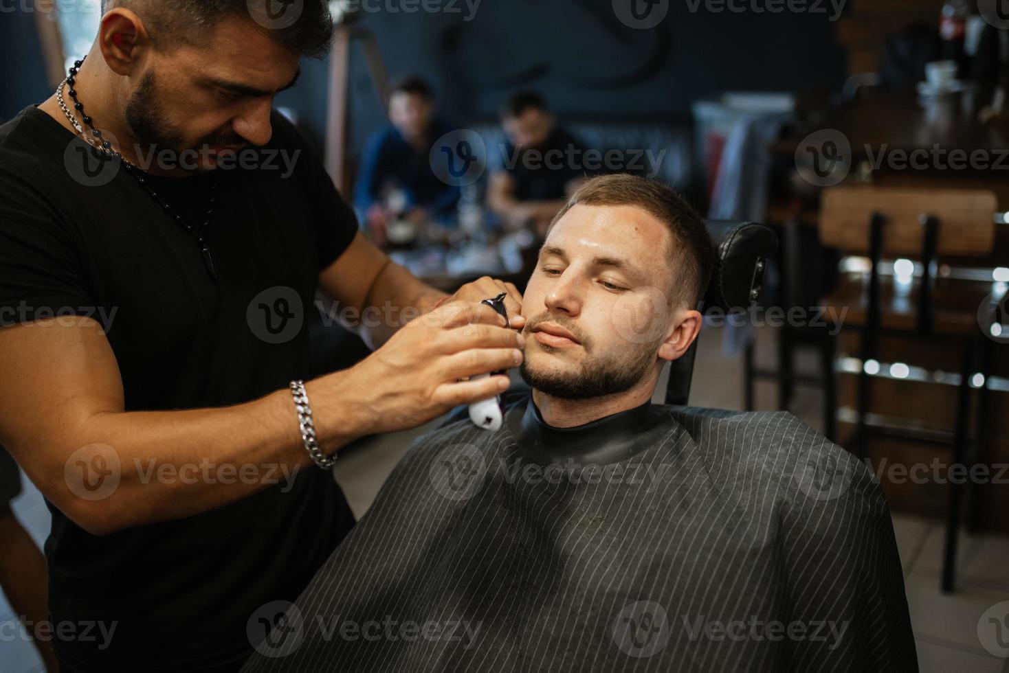 portrait of a young guy groom at the training camp in the barbershop photo