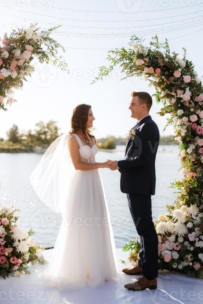 wedding ceremony on a high pier near the river photo