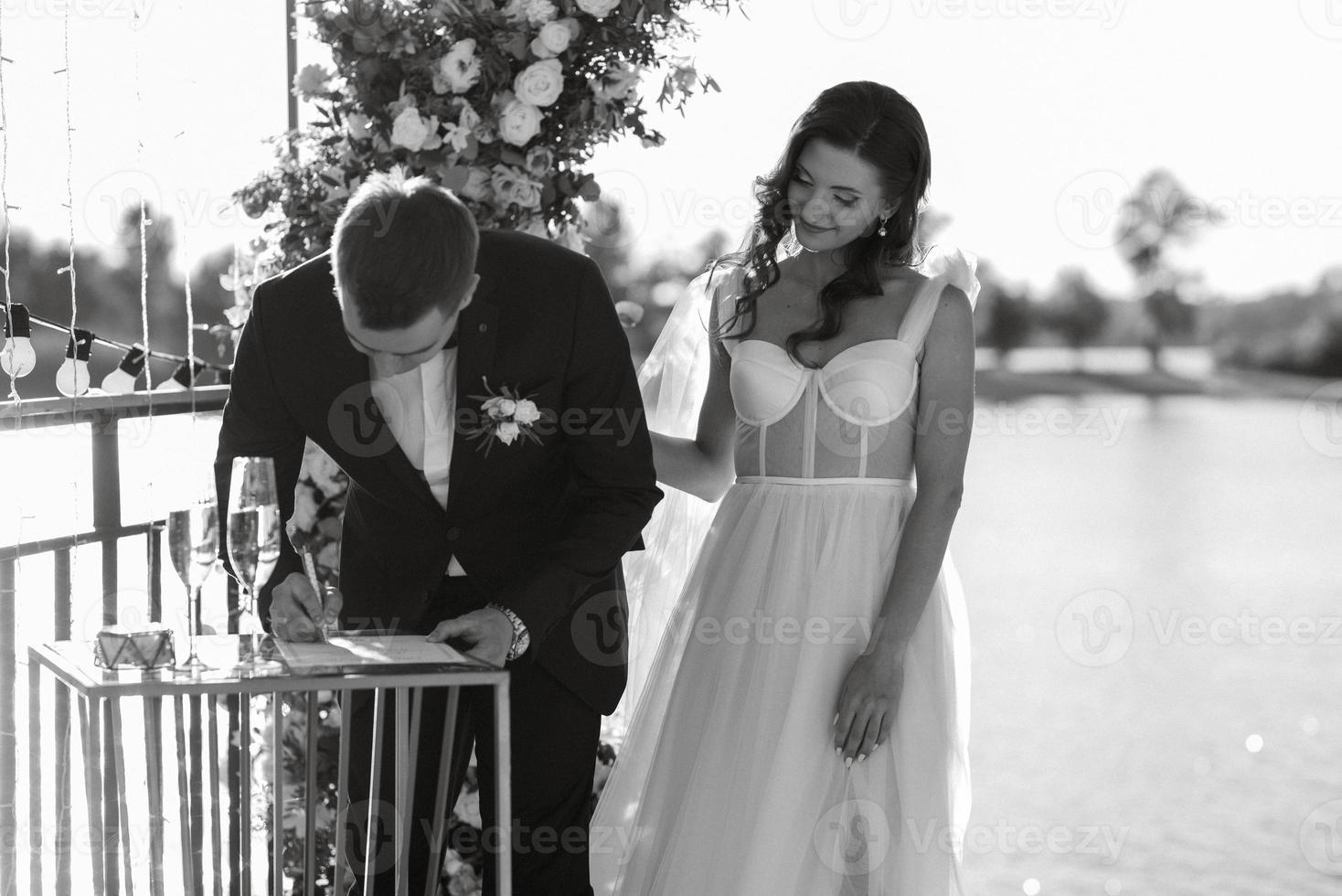 wedding ceremony on a high pier near the river photo