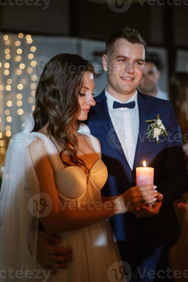 ceremony of handing over the wedding fire from parents to children with candles photo