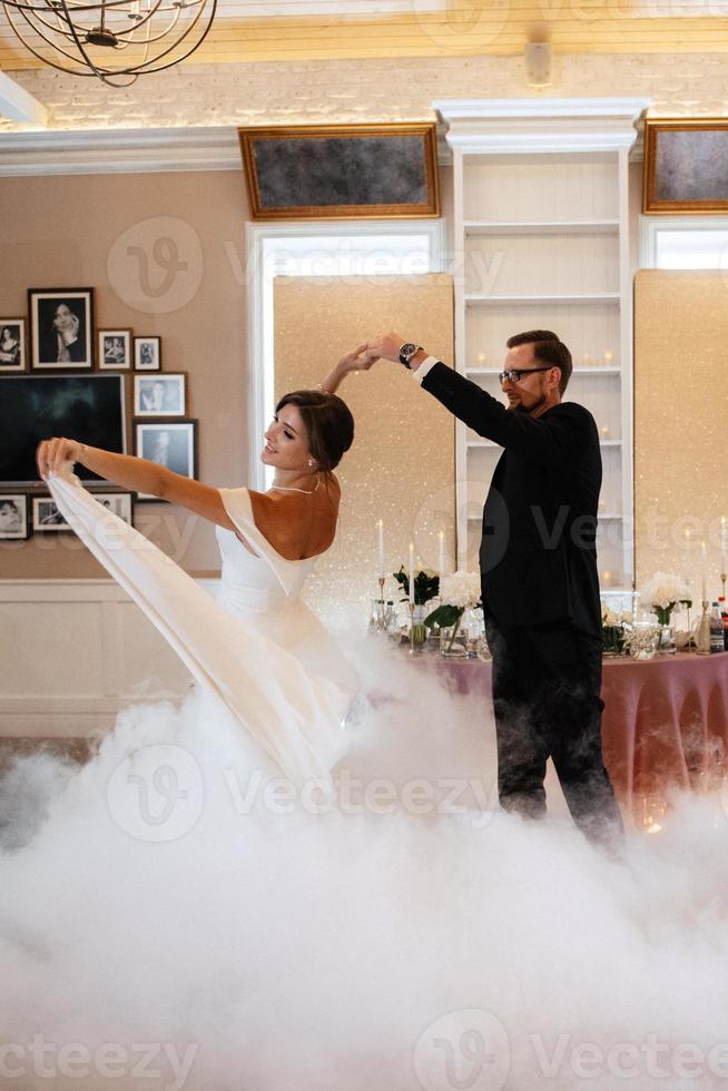 the first dance of the bride and groom inside a restaurant photo