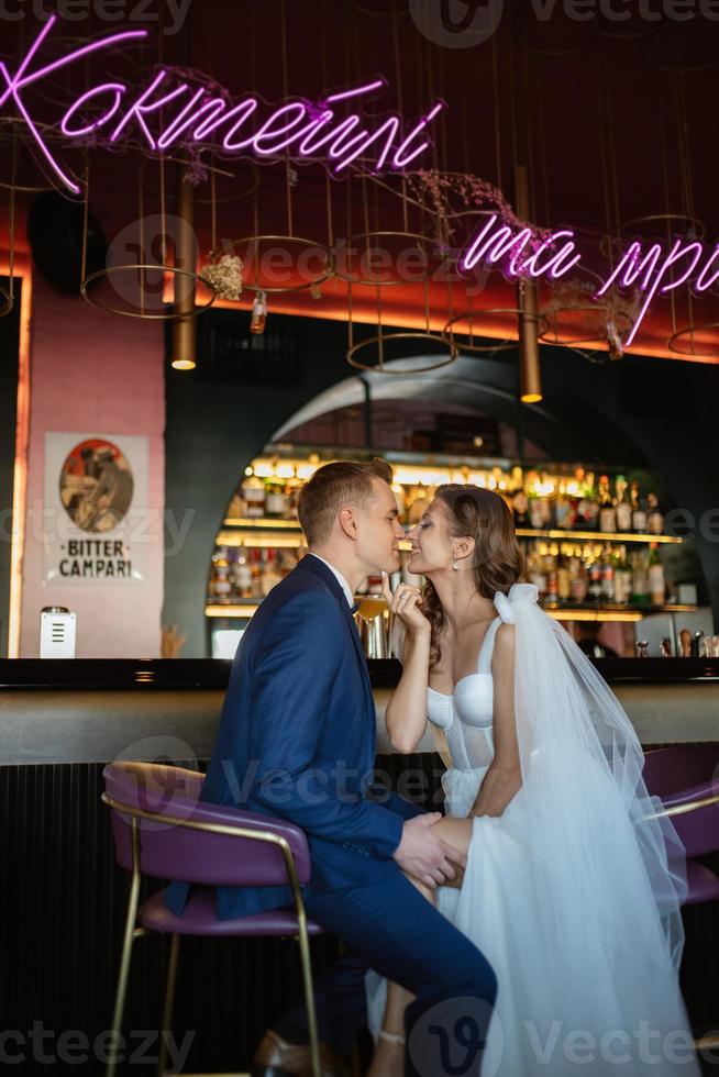 bride and groom inside a cocktail bar photo