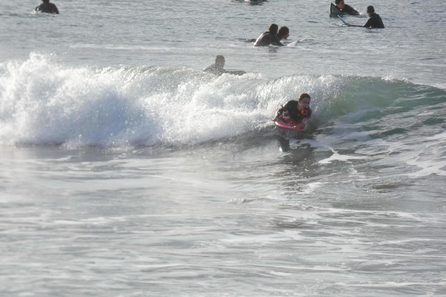 young athletes practising the water sport of surfing photo