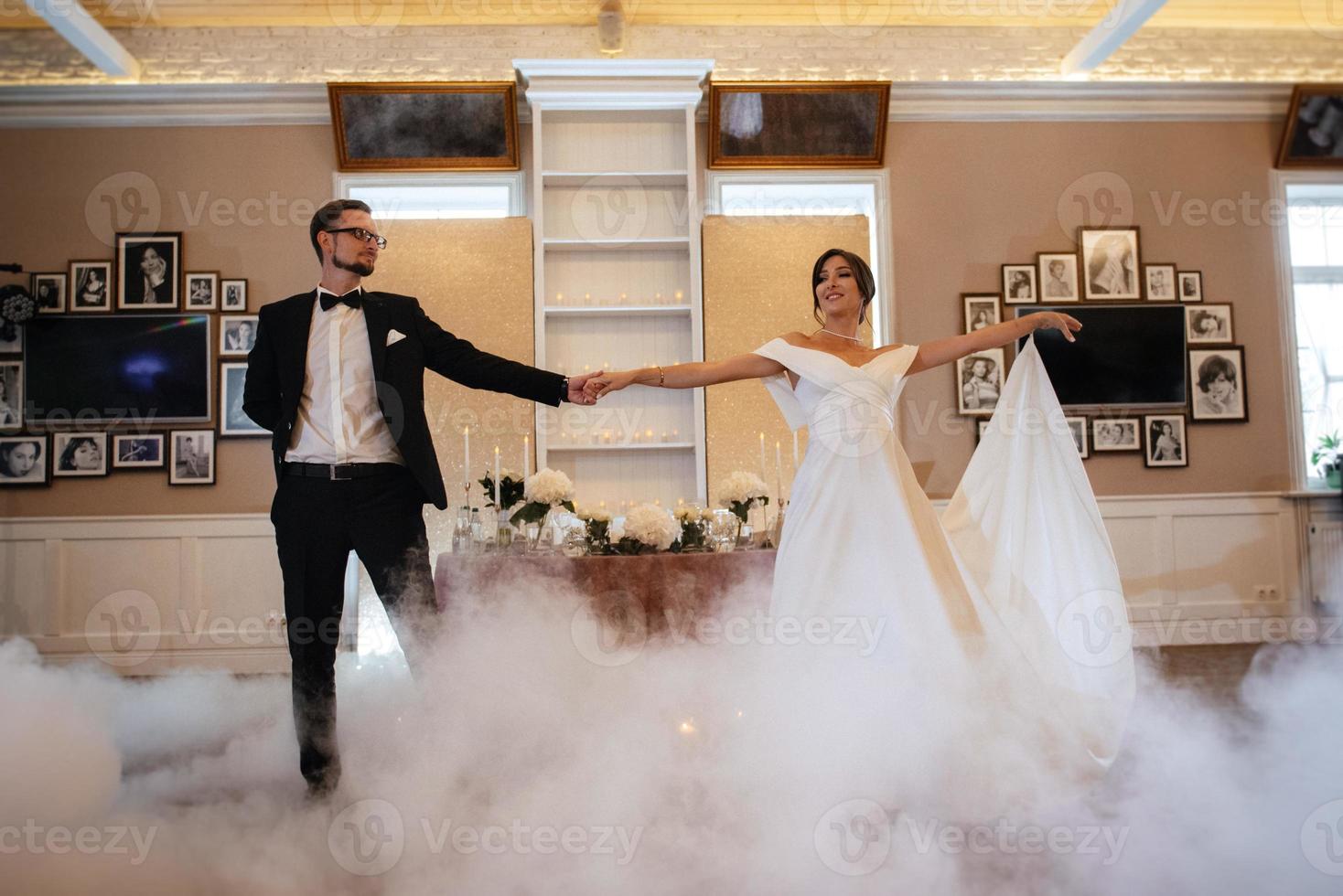 the first dance of the bride and groom inside a restaurant photo