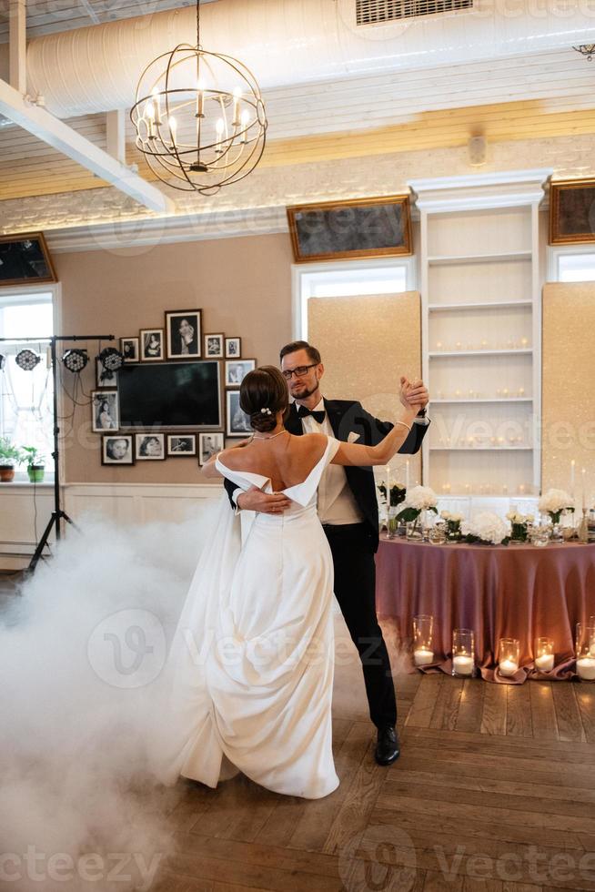 the first dance of the bride and groom inside a restaurant photo