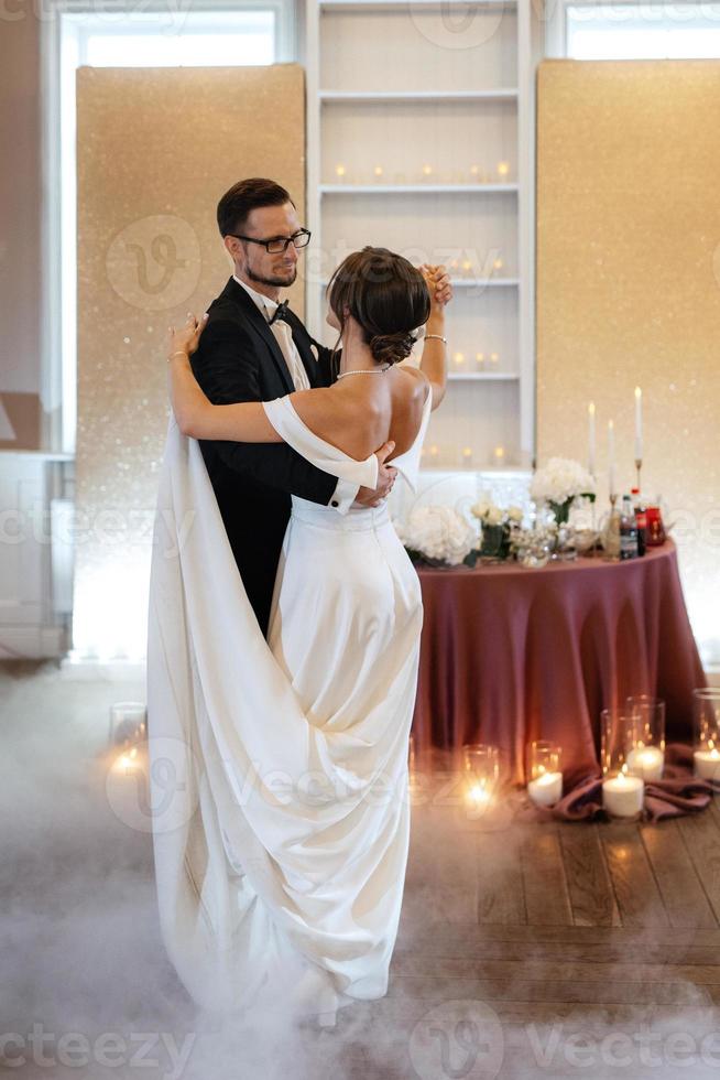 the first dance of the bride and groom inside a restaurant photo