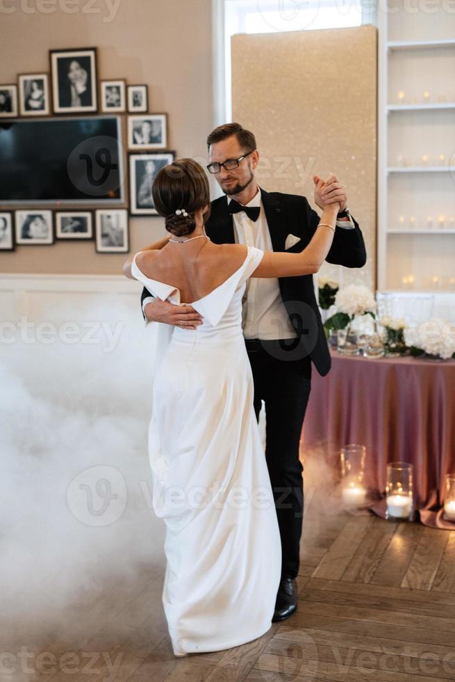 the first dance of the bride and groom inside a restaurant photo