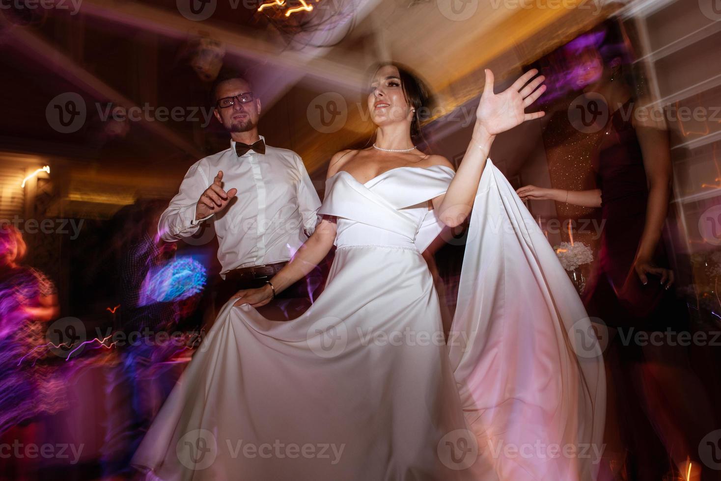 the first dance of the bride and groom inside a restaurant photo