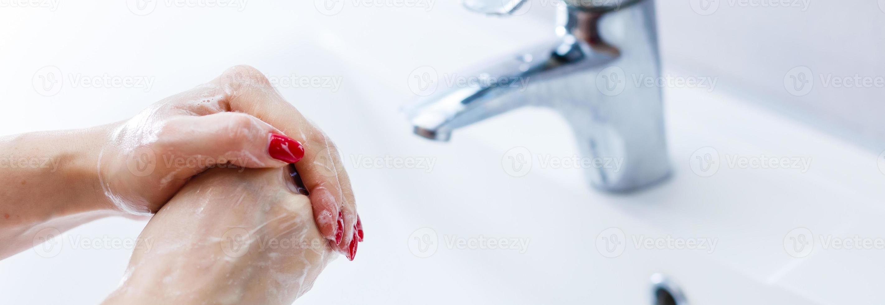 Woman washing hands over white background photo