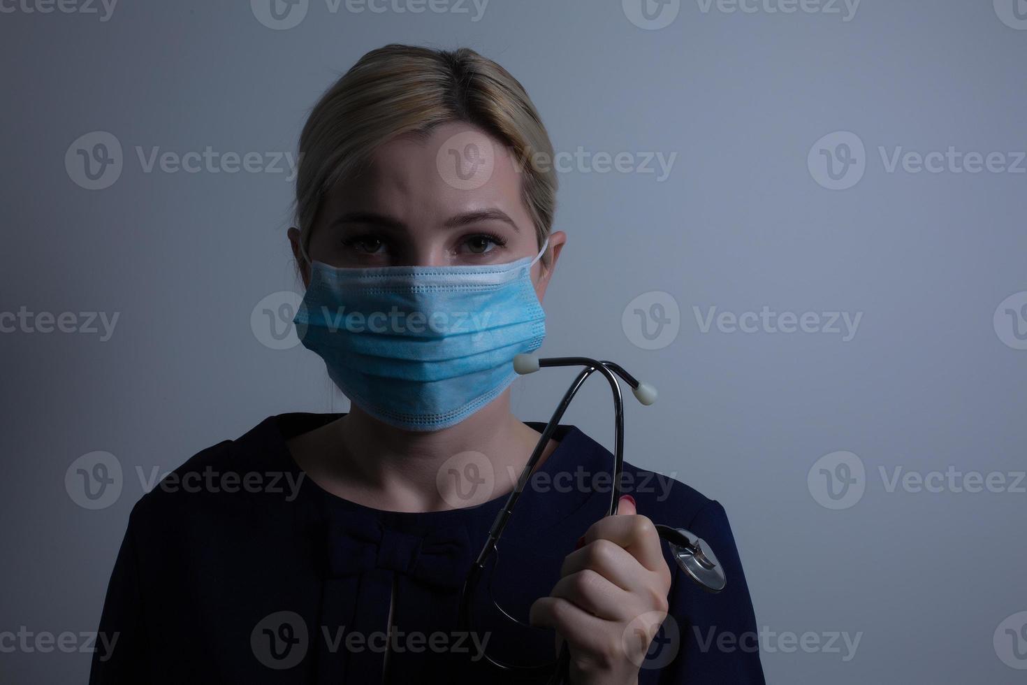 an attractive young woman wears a paper face mask to protect herself from the H1N1 Virus, isolated on white, with room for your text photo