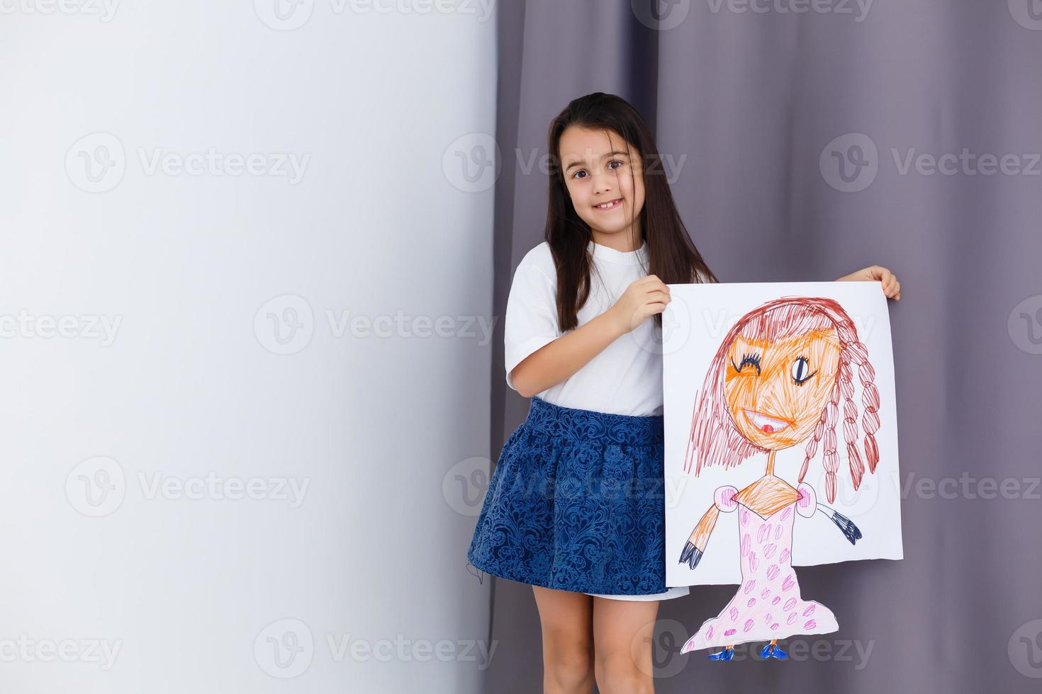 Little prescholer girl holding her portrait picture photo