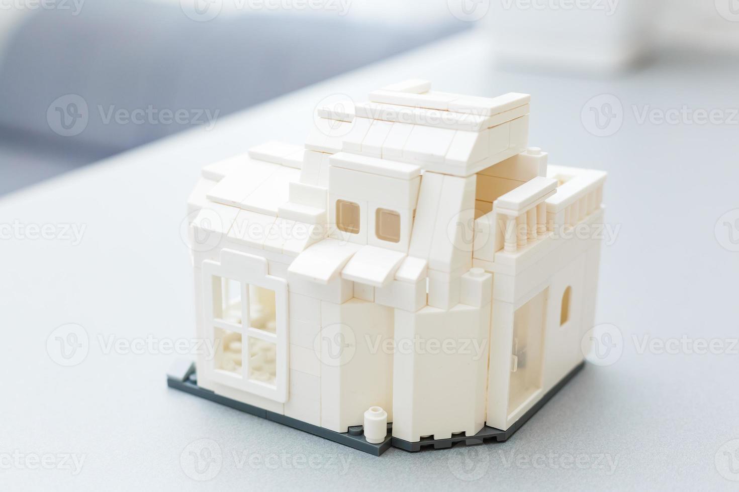 Close-up of toy house model on white background photo