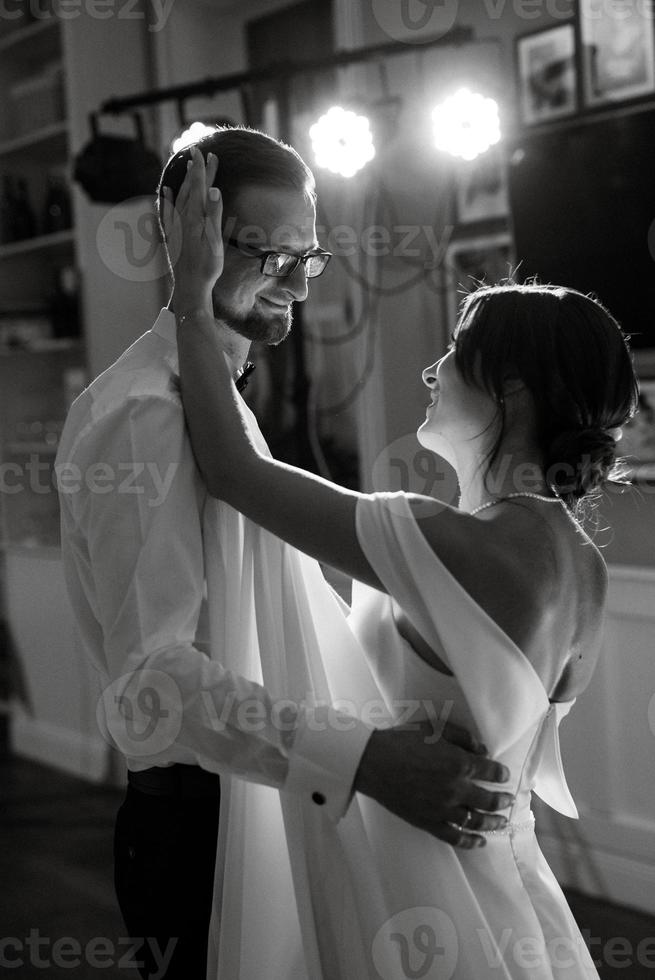 the first dance of the bride and groom inside a restaurant photo