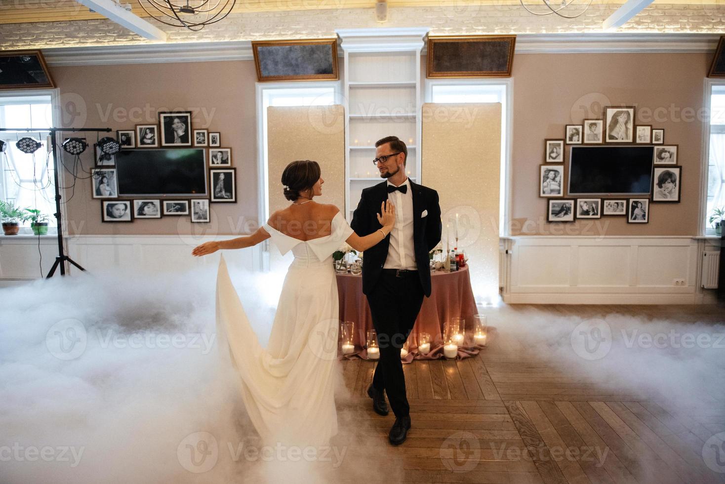 the first dance of the bride and groom inside a restaurant photo