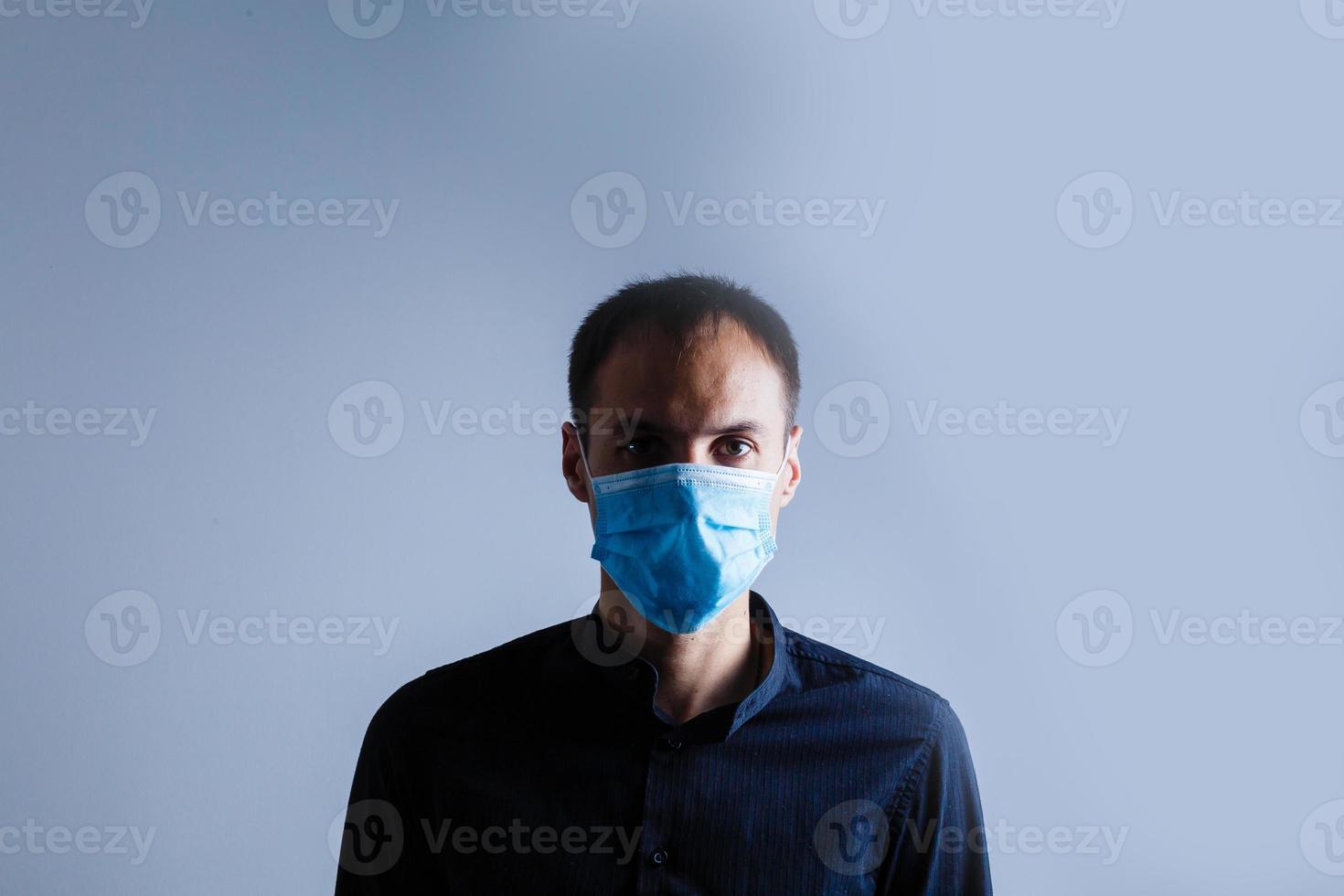 Strong man wearing mask to prevent flu virus and dust air pollution on white background photo