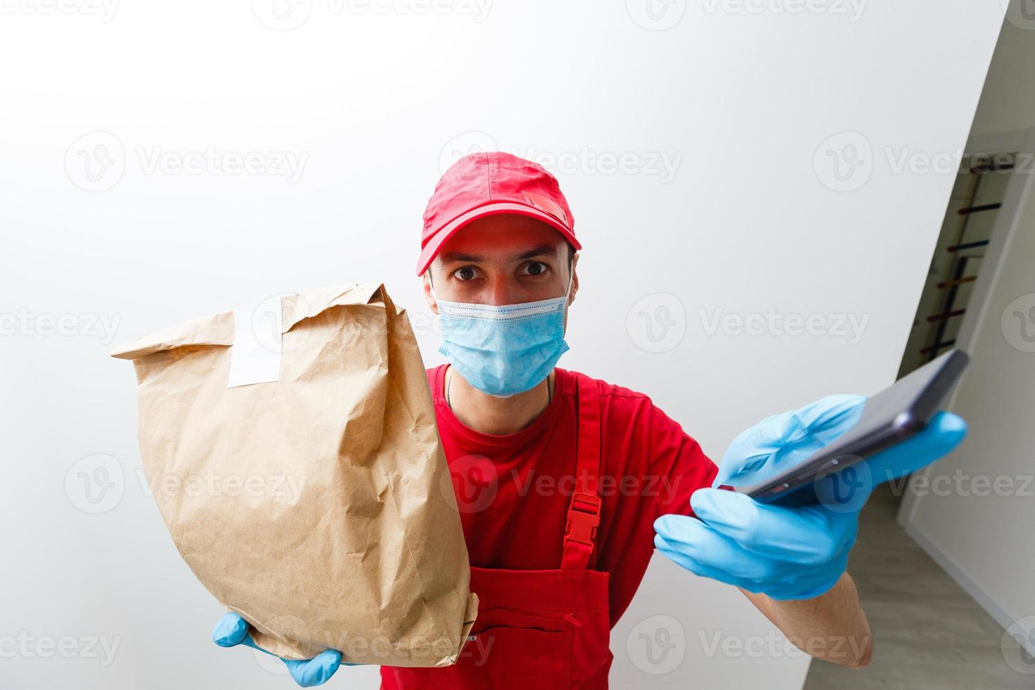 Delivery Boy With Packets Seen Through Door Viewer photo