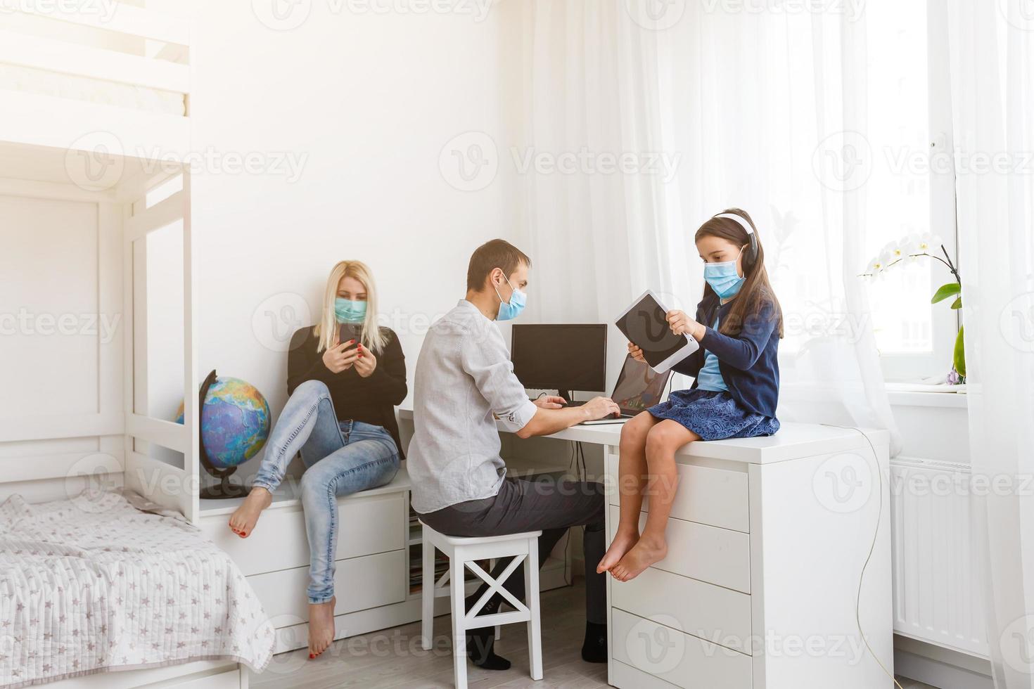 Learning at home, online learning, self quarantine concept. Family at home. Children doing homework and parents working online photo