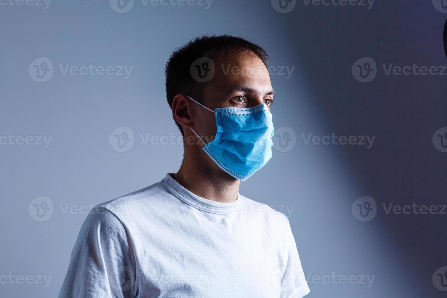 Strong man wearing mask to prevent flu virus and dust air pollution on white background photo