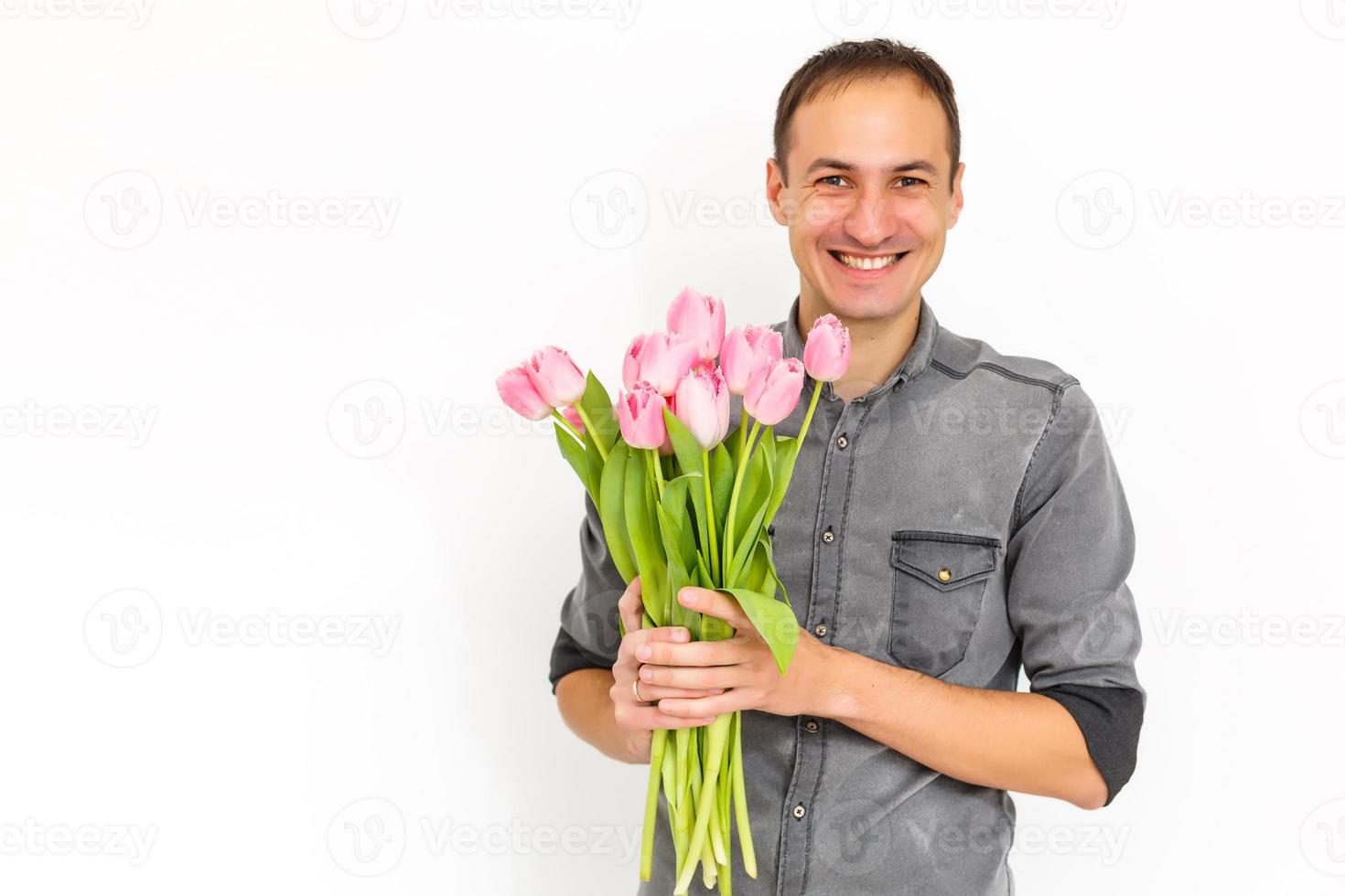 Man holding tulips. Gift card template, poster or greeting card - man holding bouquet of tulips for a woman. Mother's day, Valentine's day, Women's day concept. 8 of March gift photo