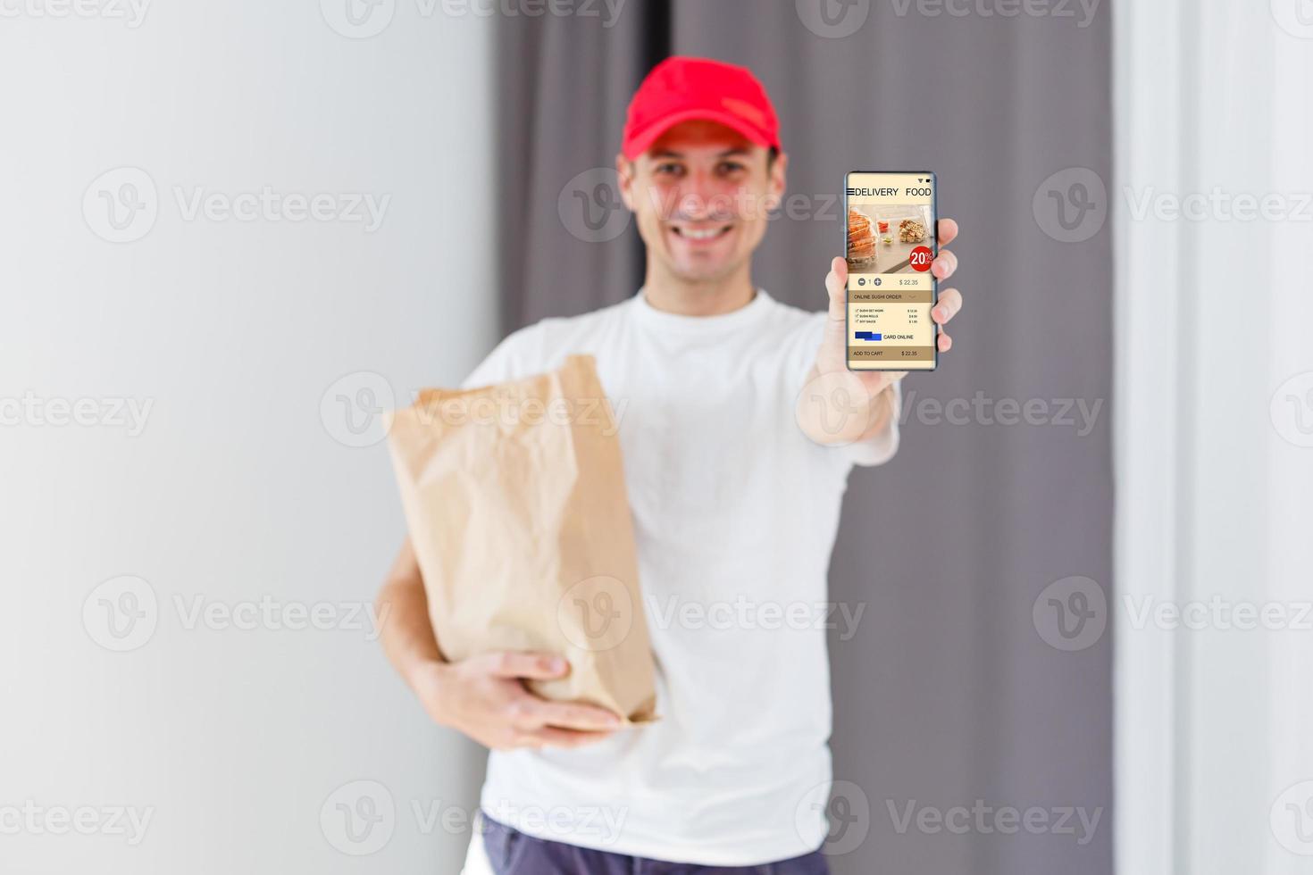 Paper pocket and food containers in hands of a smiling deliveryman. Quality service of a restaurant. photo