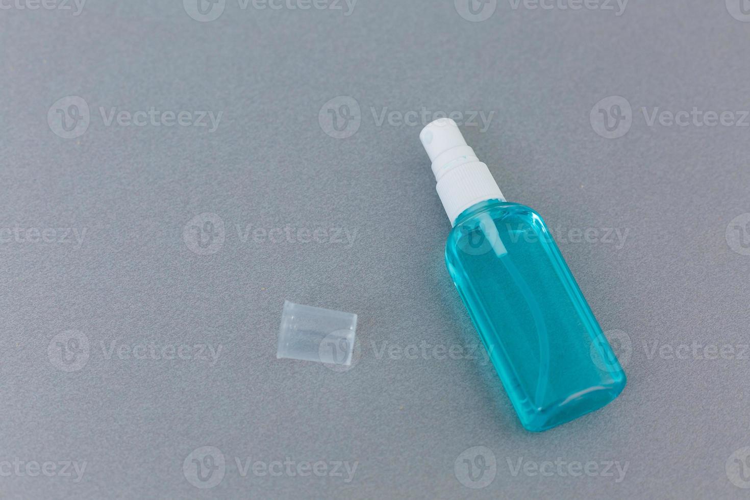 Antibacterial spray for hands antiseptic wet wipes in hands on gray background isolation photo