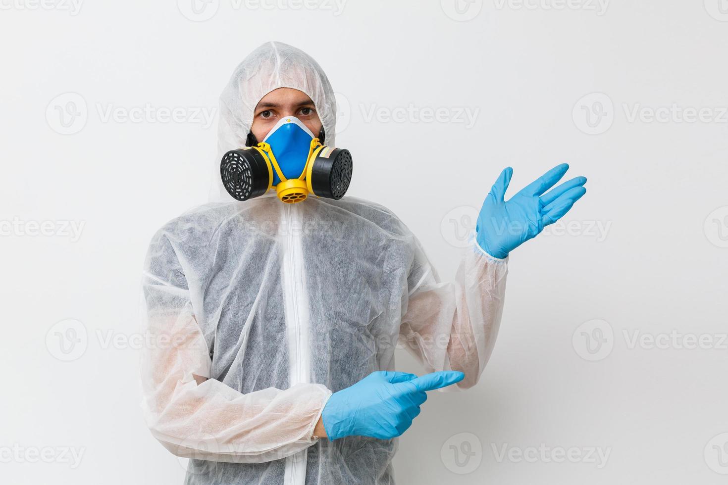 Man in protective clothing and a gasmask on a white background photo