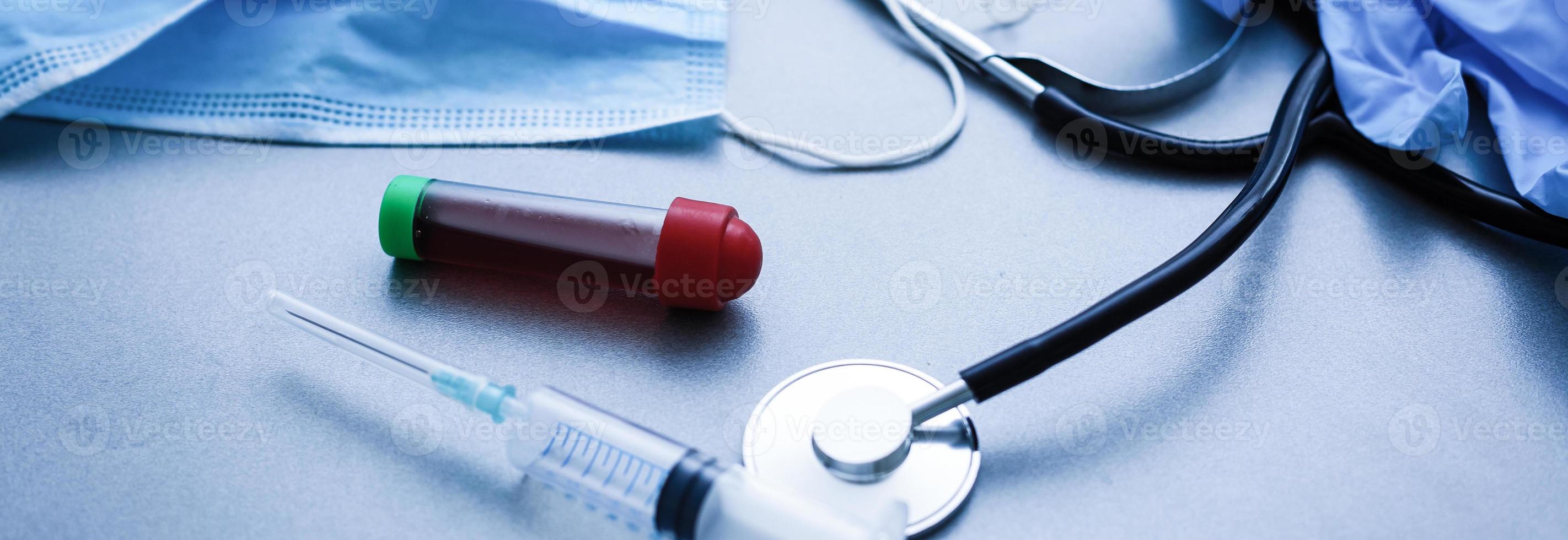 coronavirus covid 19 infected blood sample in sample tube in hand of scientist with biohazard protection clothing in coronavirus covid 19 reseach laboratory, coronavirus covid-19 vaccine research photo